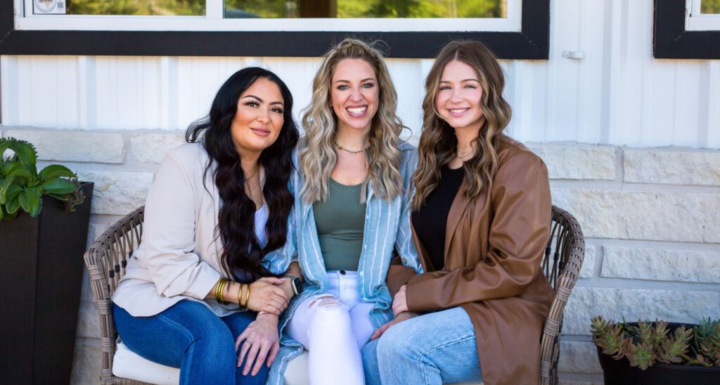 Three women smiling at camera